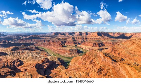 Beautiful panoramic view of famous cliffs and canyons in Dead Horse Point State Park and Colorado River meanders on a sunny day with blue sky and scenic clouds in summer, American Southwest, Utah, USA - Powered by Shutterstock