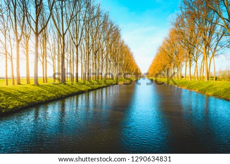 Beautiful panoramic view of famous Damme Canal, also known as Damse Vaart or Napoleonvaart, near the city of Brugge in beautiful evening light at sunset in springtime, West Flanders, Belgium
