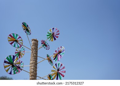A beautiful paper pinwheels, windmills of different color shades. "selective focus" " shallow depth of field" " follow focus' " blur".