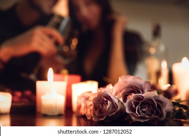 Beautiful Passionate Couple Having A Romantic Candlelight Dinner At Home, Drinking Wine, Toasting