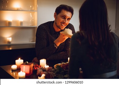 Beautiful Passionate Couple Having A Romantic Candlelight Dinner At Home, Man Kissing Hand