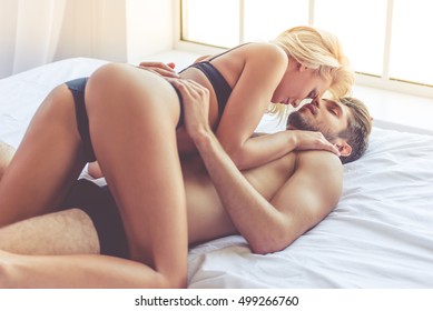 Beautiful passionate couple is having sex on bed