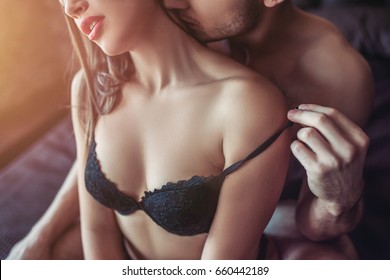 Beautiful passionate couple is having sex on bed.