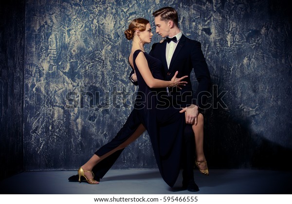 Beautiful
passionate dancers dancing tango. Professional dancers. Couple in
love dancing on a date. Love
concept.