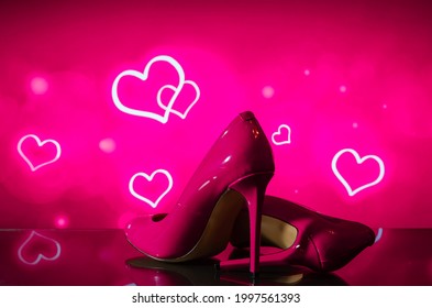 Beautiful Patent Shiny Female Pink Stiletto Heels On Blurred Background With Hearts
