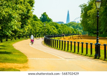 Beautiful path in the Hyde park in London with a Shard skyscraper on the horizon.
