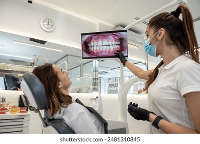 beautiful patient came to the dentistry and consults with a female doctor. dentistry consultation on further treatment - Powered by Shutterstock