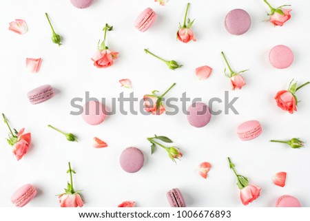 A beautiful pattern made of  macaroons and roses. flat lay,  top view, 