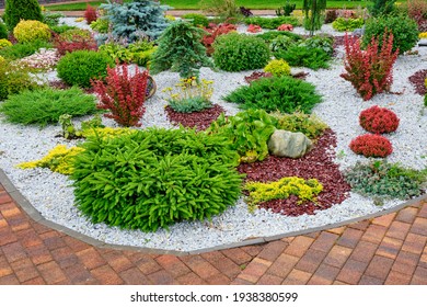 Beautiful Paving Stones, Bright Flowers And Shrubs. Pebble Gravel And Ornamental Plants. Landscaping.