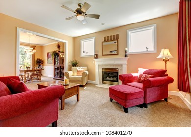 Beautiful Peach And Red Living Room Interior With Fireplace And Red Furniture.