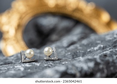 A beautiful Pearl Ear studs. Close-up of white pearl earrings.
 - Shutterstock ID 2365042461