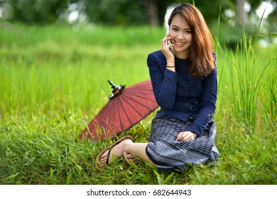 Beautiful Peasant Women Are Using Smartphones On Traditional Thai Culture.