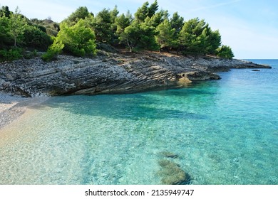 Beautiful pebbly beach in Istria. Turquoise bay in Cape Kamenjak Nature Park.