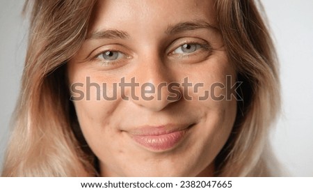 Beautiful person look at camera close up. Young adult woman face portrait. Stylish 30 years old girl on isolated white background. Attractive female feminism model. Modern millennial feminist people.