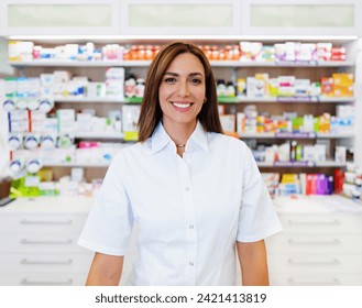 Beautiful pharmacist working and standing in a drug store and doing a stock take. Portrait of a positive healthcare worker or a chemist at his work. She is standing and looking at camera. - Powered by Shutterstock