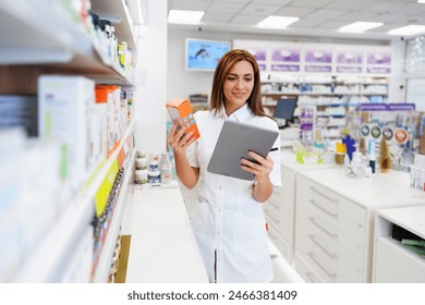 Beautiful pharmacist working and standing in a drug store and doing a stock take. Portrait of a positive healthcare worker or a chemist at his work. - Powered by Shutterstock
