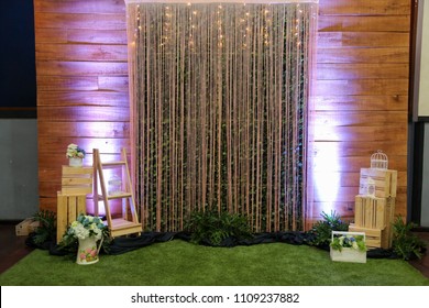 Beautiful photo booth zone at wedding or birthday reception. holiday photobooth decor with wooden boxes, flowers, and lights