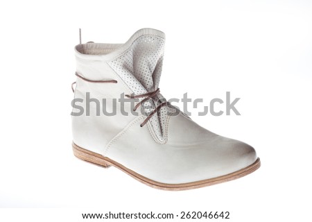 Beautiful photo of female leather boot isolated on white background. Soft white boots