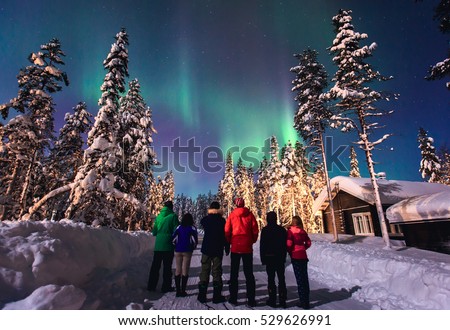 Beautiful picture of massive multicolored green vibrant Aurora Borealis, Aurora Polaris, also know as Northern Lights in the night sky over winter Lapland landscape, Norway, Scandinavia
