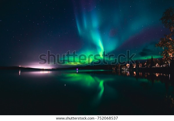 Beautiful picture of massive\
multicolored green vibrant Aurora Borealis, Aurora Polaris, also\
know as Northern Lights in the night sky over Norway,\
Scandinavia\
