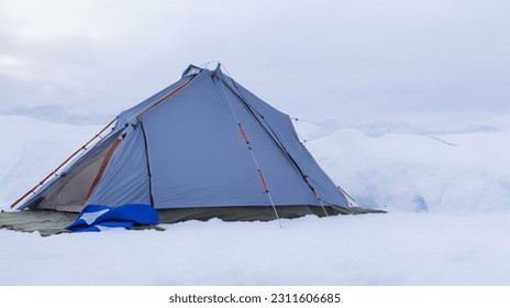 Beautiful picture of a tent in the snow - Powered by Shutterstock