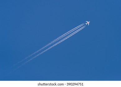 Beautiful Picture Of White Plane Flying With Trail In Blue Sky