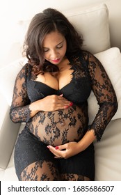 
beautiful pictures of black woman, six months pregnant brunette pregnant happily inside chick and clin room with black lace outfit