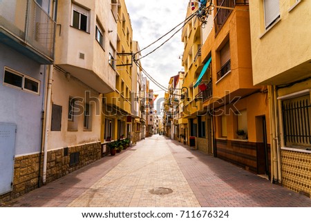 beautiful, picturesque street, narrow road, colorful facades of buildings, Spanish architecture, sunny day
