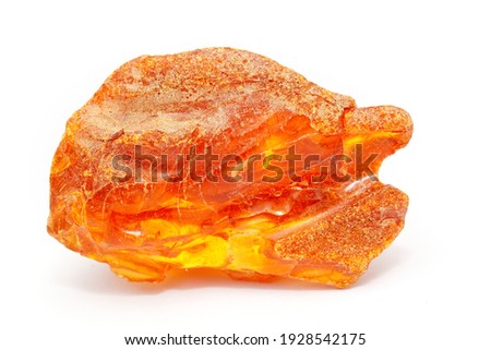 A beautiful piece of amber on a white background. Macro shot of sun stone texture. Inclusions and patterns in amber. Ancient fossil resin of trees. Material for jewelers. Copal. Natural mineral