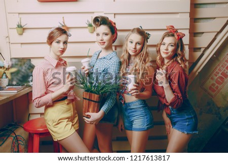 beautiful pin up girls in a cafe with flowerpoot