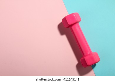 Beautiful Pink Dumbbell For Fitness On Light Pink And Turquoise Background