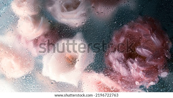 Beautiful pink flower bouquet in raindrops. Abstract floral background in muted colors.