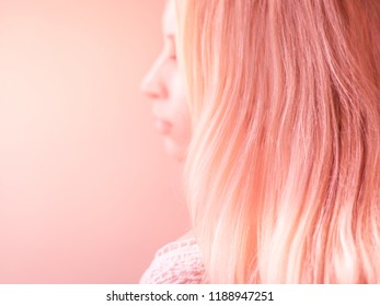 Beautiful Pink Hair On A Pink Pastel Background, Side View Portrait With Blurred Face