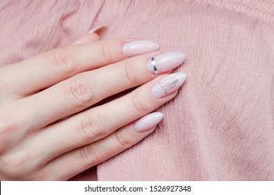 
Beautiful pink manicure with a trendy design on a pink background