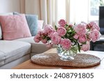 Beautiful pink peonies in vase on table at home, space for text. Interior design