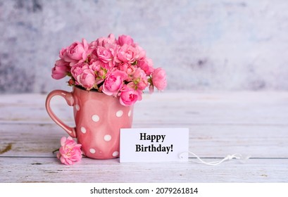 Beautiful Pink Roses in  Vase and Happy Birthday card  on Grey Background  