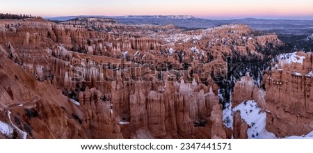 A beautiful pink sunset glows over Bryce Canyon National Park in Utah. 