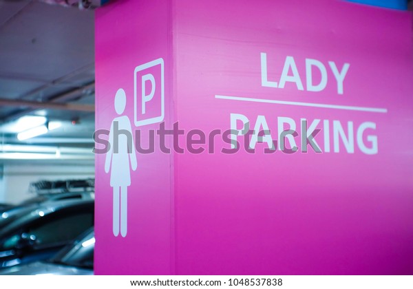 Beautiful\
pink women sign Parking in the shopping\
mall.
