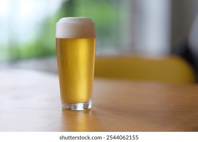 Beautiful pint of lager with a foamy head, clear, crisp. Refreshment artisanal craft beer on a table, high angle, depth of field. - Powered by Shutterstock