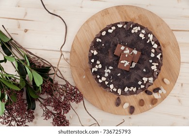 A Beautiful Plate Of Raw Vegan Snickers Cake With Flowers Alongside In A Little Pastry.