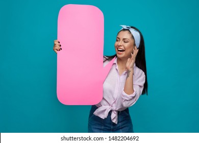 Beautiful, playful girl posing with pink paper speech bubble, smiling. Happy, positive model wearing in pink shirt, blue headband and jeans skirt having perfect straight black hair. - Powered by Shutterstock