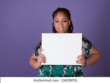 Beautiful plus size black woman holding a sign