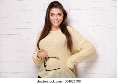 Beautiful Plus Size Female Model Posing In Studio.