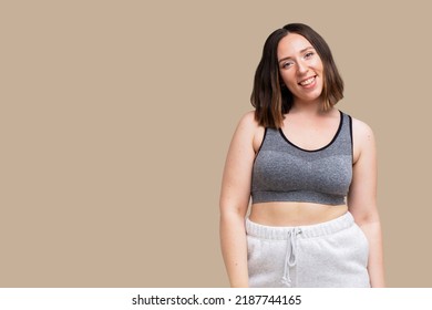 Beautiful Plus Size Model Smiling In Sport Outfit Yoga Outfit Isolated On Beige