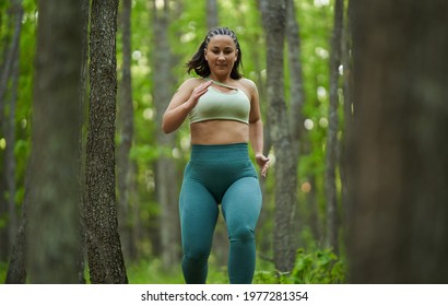 Beautiful Plus Size Runner Woman Running On A Dirt Road In The Forest