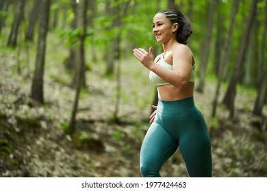 Beautiful Plus Size Runner Woman Running On A Dirt Road In The Forest