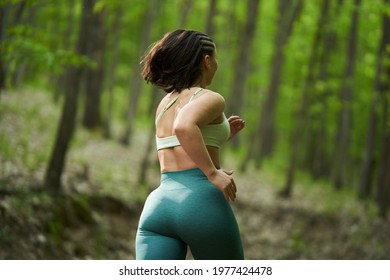 Beautiful Plus Size Runner Woman Running On A Dirt Road In The Forest