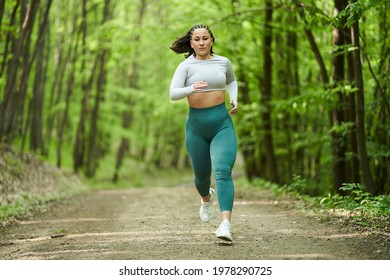 Beautiful Plus Size Runner Woman Running On A Dirt Road In The Forest