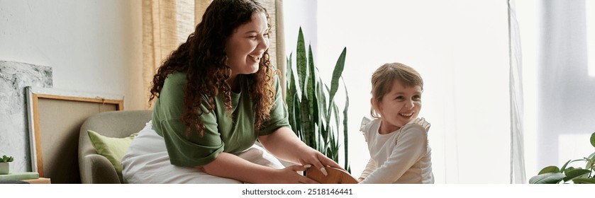 A beautiful plus size woman and her daughter share laughter and joy while playing together indoors. - Powered by Shutterstock