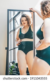 Beautiful Plus Size Woman Looking In Mirror At Home. 